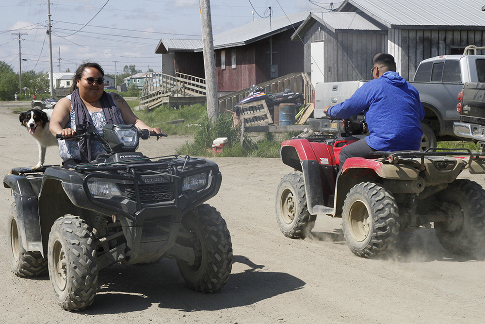 Residents ride all-terrain vehicles on the dusty streets of Kwethluk, Alaska, on June 19, 2025. (AP/Mark Thiessen)
