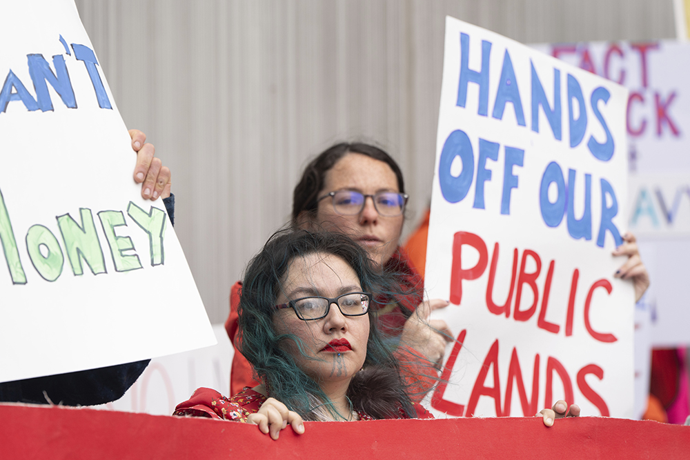 Demonstrators hold signs during a protest outside the annual Alaska Sustainable Energy Conference on June 3, 2025, in Anchorage, Alaska. (AP/Jenny Kane, File)