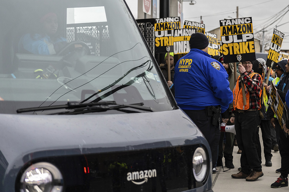 Amazon workers and members of the International Brotherhood of Teamsters picket in front of the Amazon fulfillment center in the Queens borough of New York Dec. 20, 2024. (AP/Stefan Jeremiah)