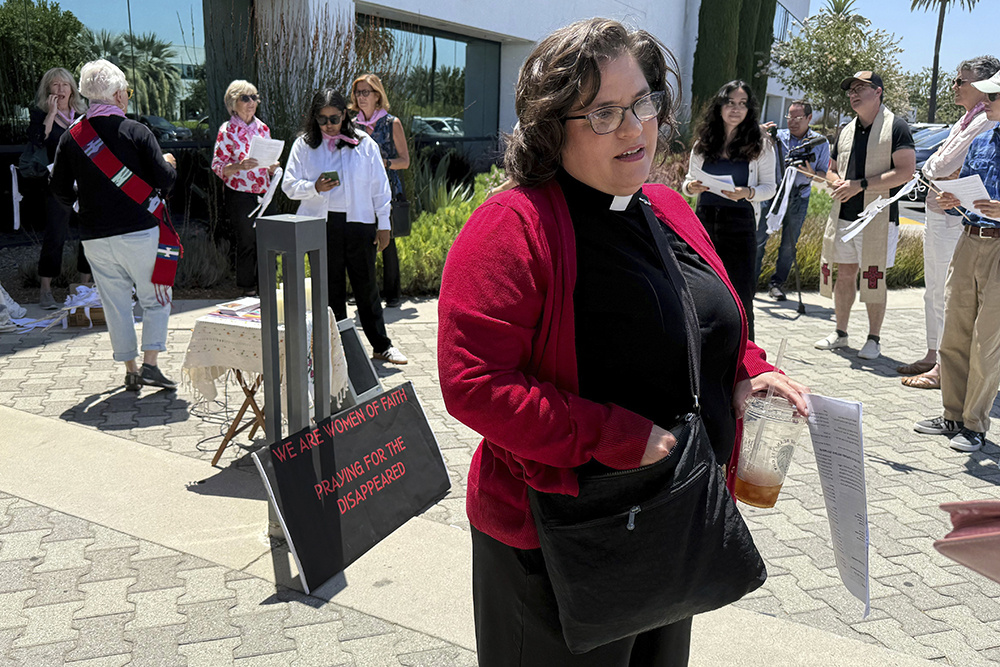 The Rev. Oona Casanova Vazquez, lead pastor of the South Bay Church of the Nazarene in Torrance, stands outside Santa Ana Immigration Court during a prayer vigil for immigrants in Santa Ana, Calif., July 31, 2025. (AP Photo/Deepa Bharath)