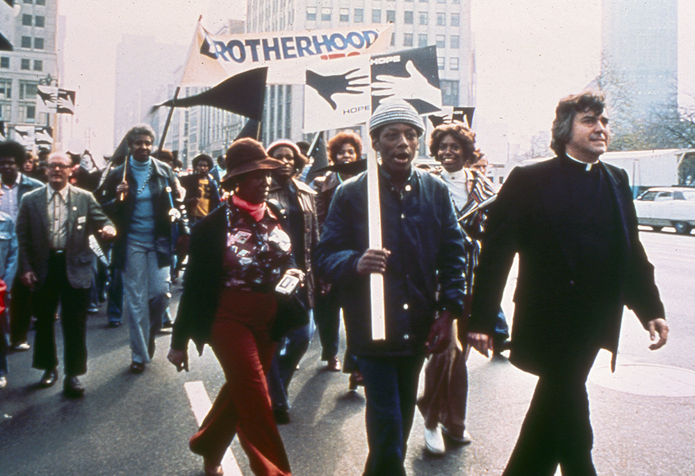 Fr. William Cunningham leads an annual Walk for Focus: HOPE in Detroit in the early 1970s. Sacred Heart Seminary's activism intensified in 1965 after the police attack on civil rights marchers in Selma, Alabama. Several Sacred Heart faculty members, including Cunningham, flew to Selma to join the second march with Dr. Martin Luther King Jr. (Courtesy of Focus: HOPE)