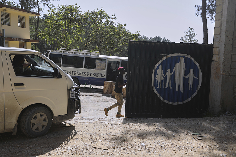 Workers enter the Saint-Helene orphanage in the Kenscoff neighborhood of Port-au-Prince, Haiti, Aug. 4, 2025. (AP Photo/Odelyn Joseph)