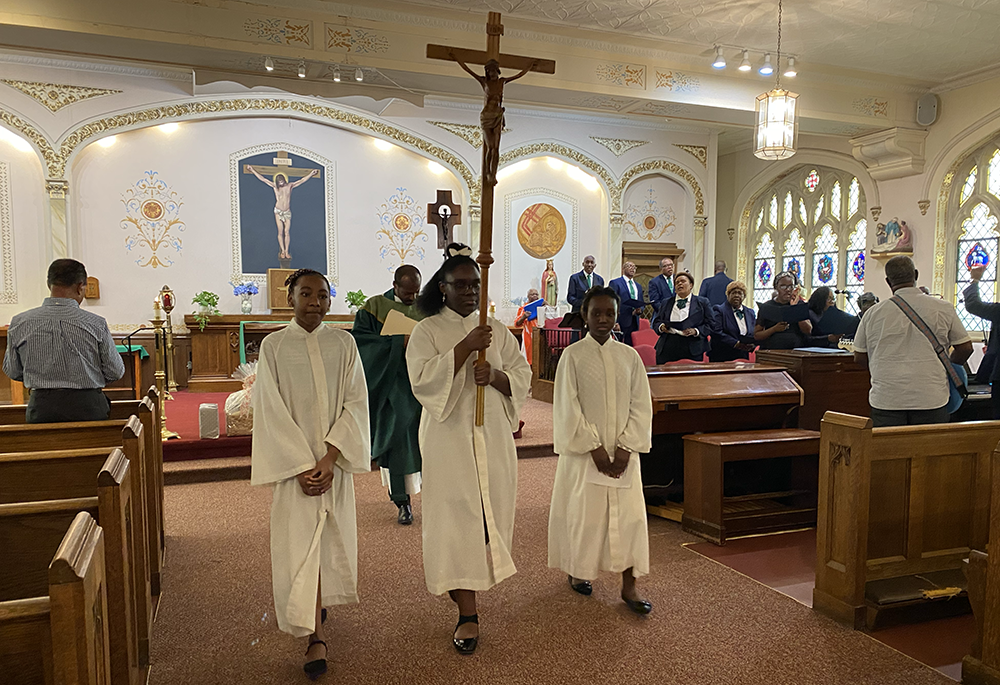 Altar servers join Oblate Fr. Eugène Almonor for closing procession at St. Barbara Catholic Church in Philadelphia, on July 20, 2025. (NCR photo/Renée Roden)