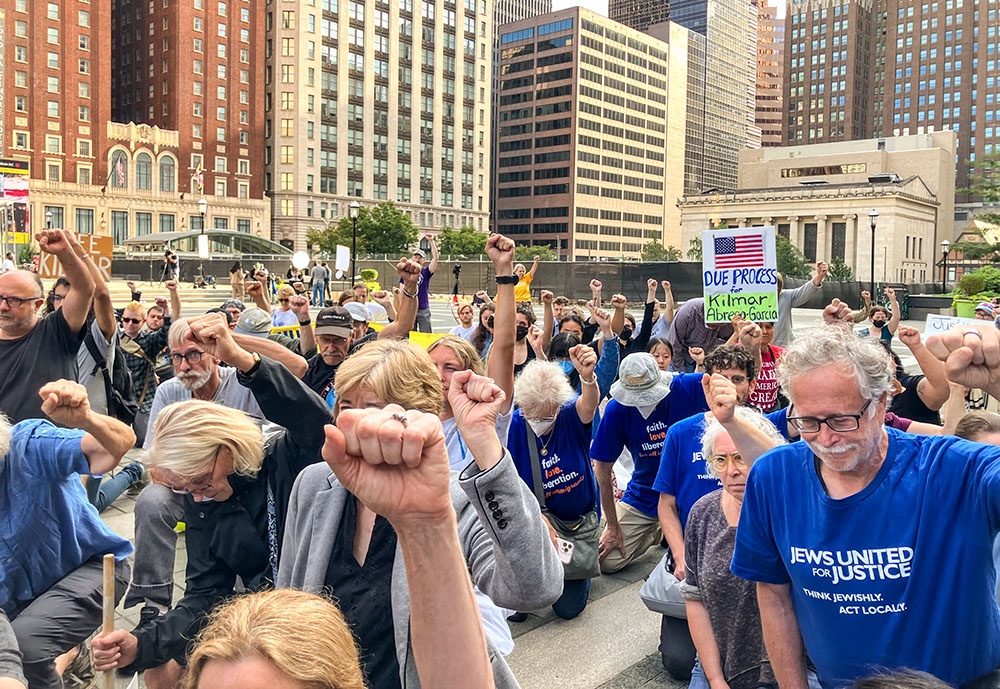 Participants at an Aug. 25 rally in Baltimore for Kilmar Ábrego García raise fists opposing harsh treatment of immigrants. (Patricia Zapor)