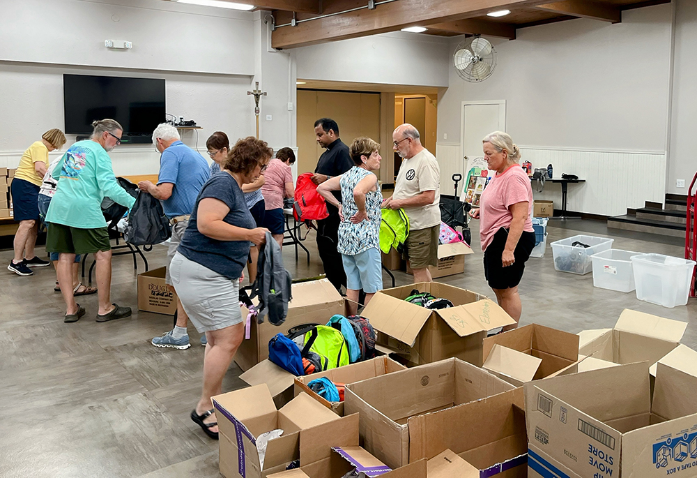 Lisa Neuhauser, far right, volunteers in 2024 with fellow parishioners from Holy Spirit Catholic Church in Palmyra, Pennsylvania to organize backpacks for migrant children. (Courtesy of Lisa Neuhauser)