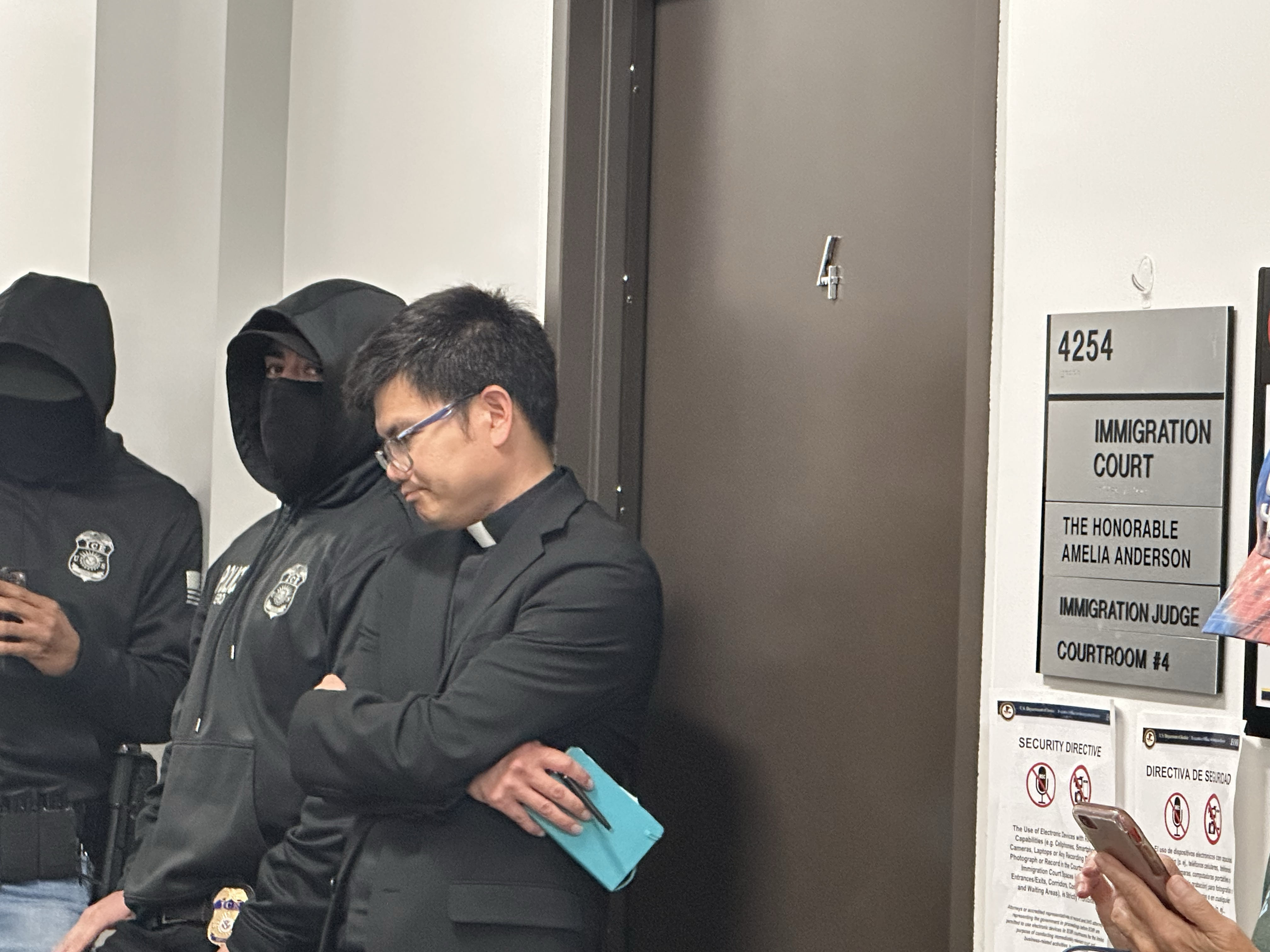 The Rev. Hung Nguyen, SJ, of Our Lady of Guadalupe Church in San Diego waits outside immigration court Aug. 6, 2025, the second day of the San Diego diocese's FAITH ministry. (NCR photo/Chris Stone)