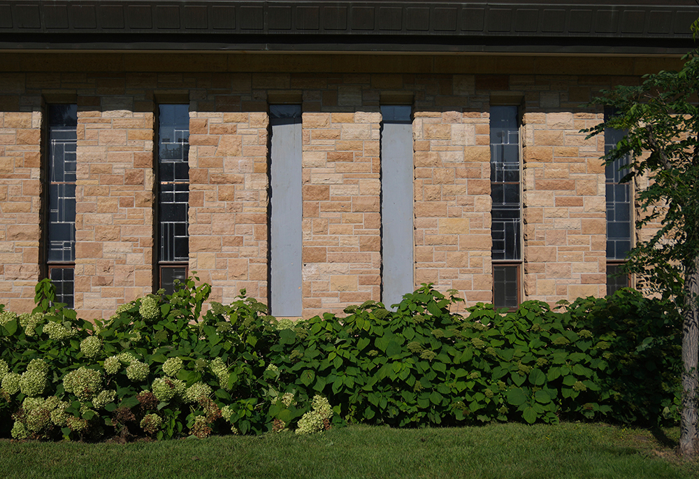 The damaged windows are boarded up at Annunciation Catholic Church after Wednesday's school shooting, Thursday, Aug. 28, 2025, in Minneapolis. (AP photo/Abbie Parr)