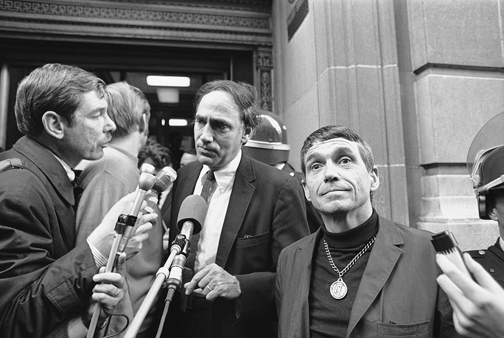 Jesuit Fr. Daniel Berrigan, right, and William Kunstler, defense lawyer, talk with reporters in Baltimore Nov. 9, 1968, after the trial and conviction of the Catonsville Nine. In May that year, Berrigan and eight other Catholics broke into a Selective Service office outside of Baltimore and burned 378 draft files — while reciting the Lord's Prayer — to protest the Vietnam War. (AP/William A. Smith)