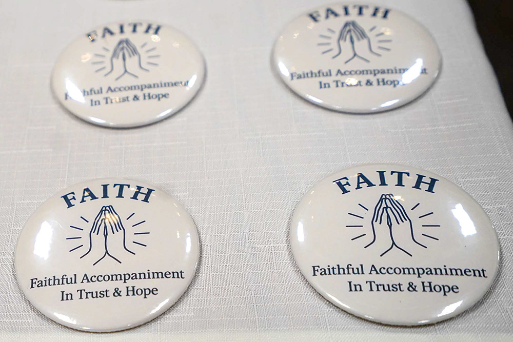 Accompaniment volunteers will wear buttons to identify themselves as part of the ministry. (NCR photo/Chris Stone)
