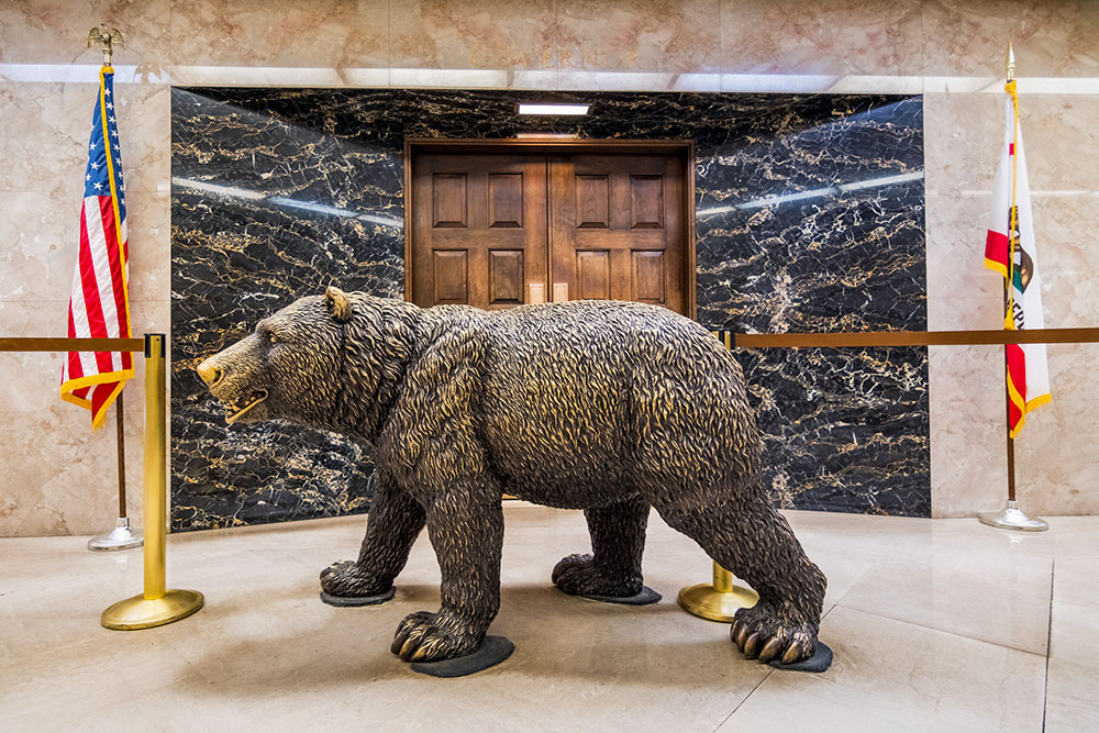A statue of a grizzly bear stands in front of doors to the governor's office in the California State Capitol building in Sacramento. (Dreamstime/Andreistanescu)