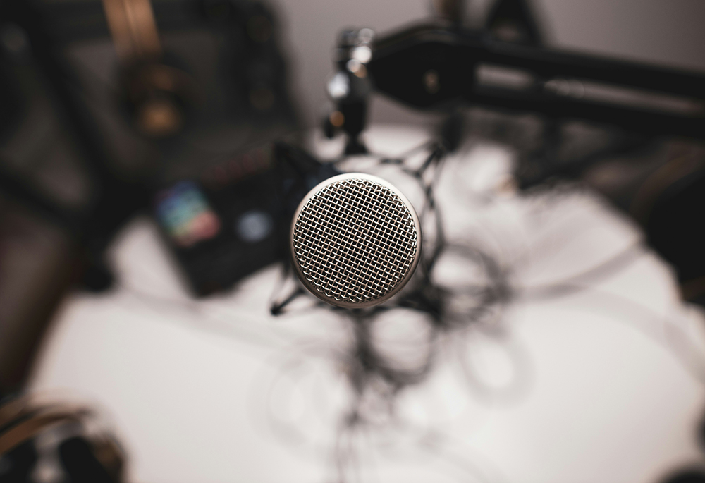 A microphone used for podcasting is pictured. "Whether through podcasts, TikTok videos or Substack posts, a liberatory Catholic media landscape meets people where they are, especially those hurt by the very institution claiming to represent them," Maxwell Kuzma writes. (Unsplash/Jonathan Farber)