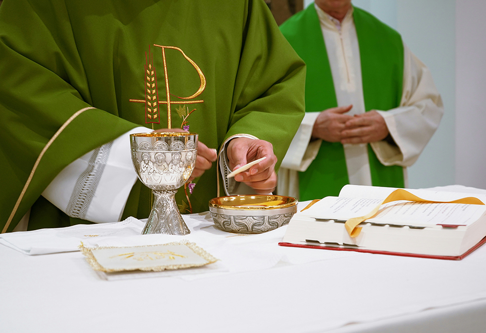 A priest celebrates the Liturgy of the Eucharist. (Unsplash/Lennon Caranzo)