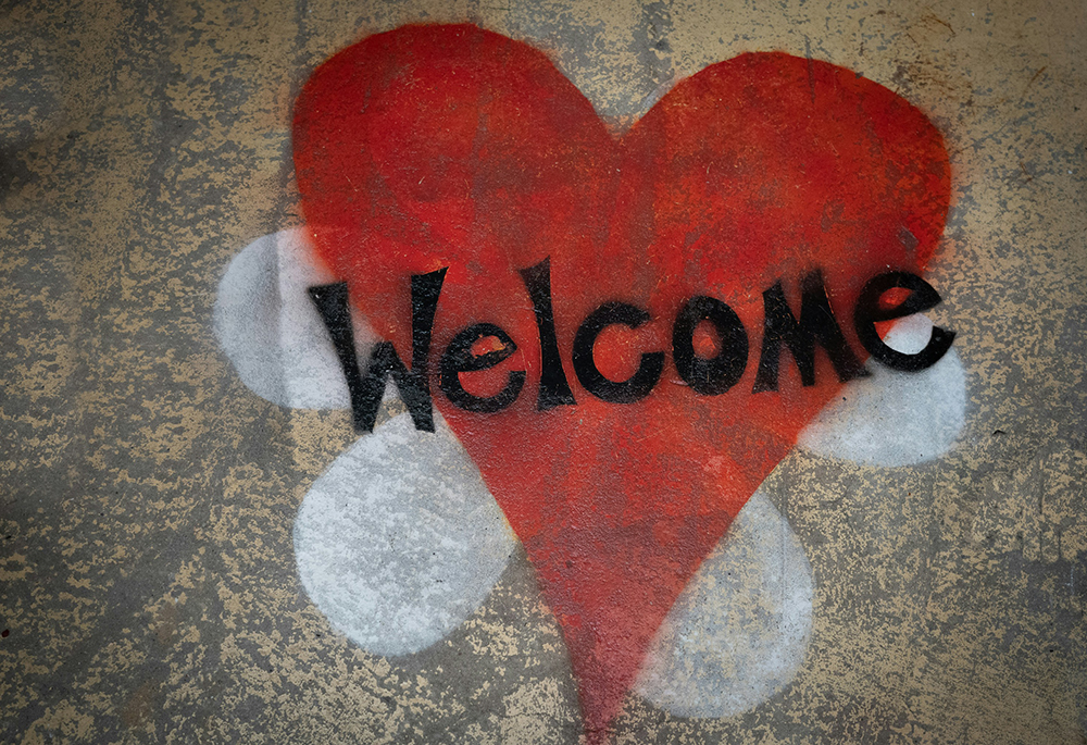 A red heart is displayed spray painted on a tan wall in this photo illustration. (Unsplash/Nick Fewings)