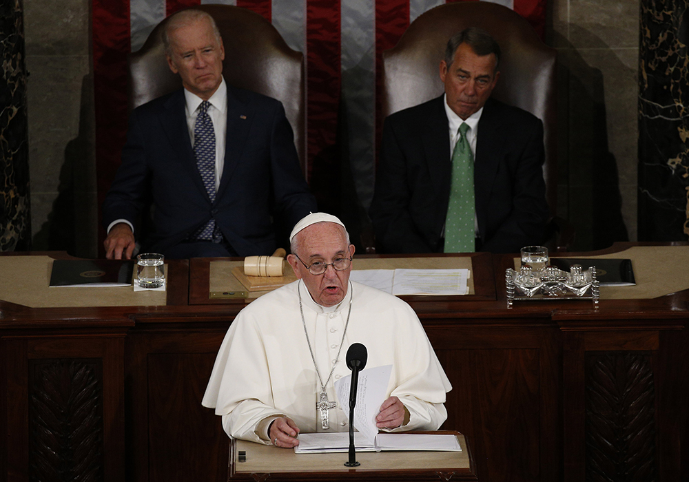 Pope Francis addresses a joint meeting of the U.S. Congress as then-Vice President Joe Biden (left) and then-Speaker of the House John Boehner look on in the House of Representatives Chamber at the U.S. Capitol in Washington Sept. 24, 2015. (CNS/Paul Haring)