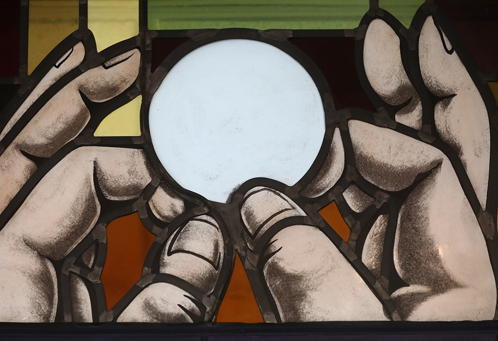 Elevation of the Eucharist is depicted in a stained-glass window at St. Anthony's Church in North Beach, Maryland, July 15, 2021. (CNS/Bob Roller)