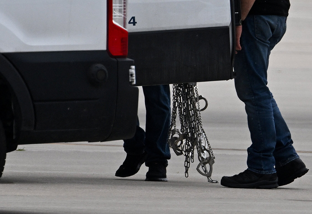 Handcuffs are carried after being removed from detained migrants who boarded a plane after being transferred from an ICE detention facility, at Gary/Chicago International Airport, in Gary, Indiana, June 20, 2025. (OSV News/Reuters/Dylan Martinez)