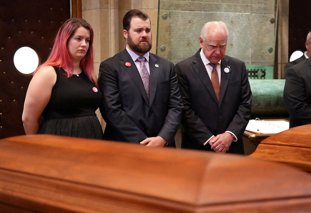 Sophie Hortman and Colin Hortman stand behind the caskets of their parents, Melissa and Mark Hortman, alongside Minnesota Gov. Tim Walz, during their funeral Mass at the Basilica of St. Mary in Minneapolis June 28, 2025. Melissa Hortman, a Minnesota state representative, and her husband were shot and killed early June 14, in what appeared to be a targeted attack against state lawmakers. (OSV News/Reuters/Alex Kormann)