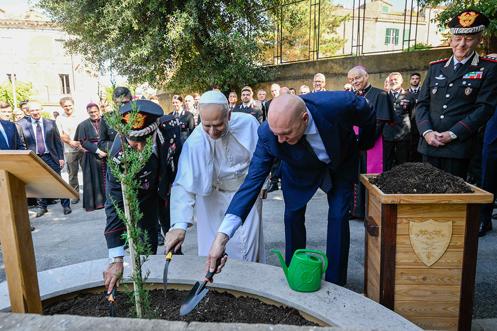 Pope Leo XIV takes part in a tree-planting ceremony with officers of the Italian Carabinieri at their headquarters in Castel Gandolfo July 15, 2025. The young cypress tree had been propagated using small pieces of plant tissue taken from the 830-year-old "Cypress of St. Francis," the oldest cypress tree in Italy. (CNS/Vatican Media)