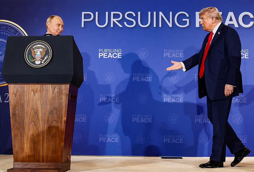U.S. President Donald Trump walks towards Russian President Vladimir Putin during a press conference following their meeting to negotiate an end to the war in Ukraine, at Joint Base Elmendorf-Richardson, in Anchorage, Alaska, Aug. 15, 2025. (OSV News/Reuters/Kevin Lamarque)