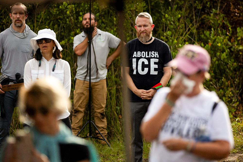 People attend a vigil in support of immigration detainees at the entrance of the "Alligator Alcatraz" Immigration and Customs Enforcement detention center at the Dade-Collier Training and Transition Airport in Ochopee, Fla., Aug. 10, 2025. (OSV/Reuters/Marco Bello)