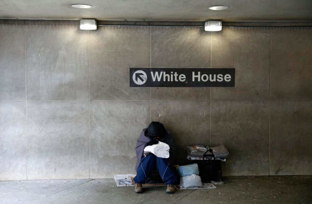 A file photo shows a homeless person trying to stay warm at the entrance of a Metro station near the White House in Washington. (OSV News/Reuters/Kevin Lamarque)