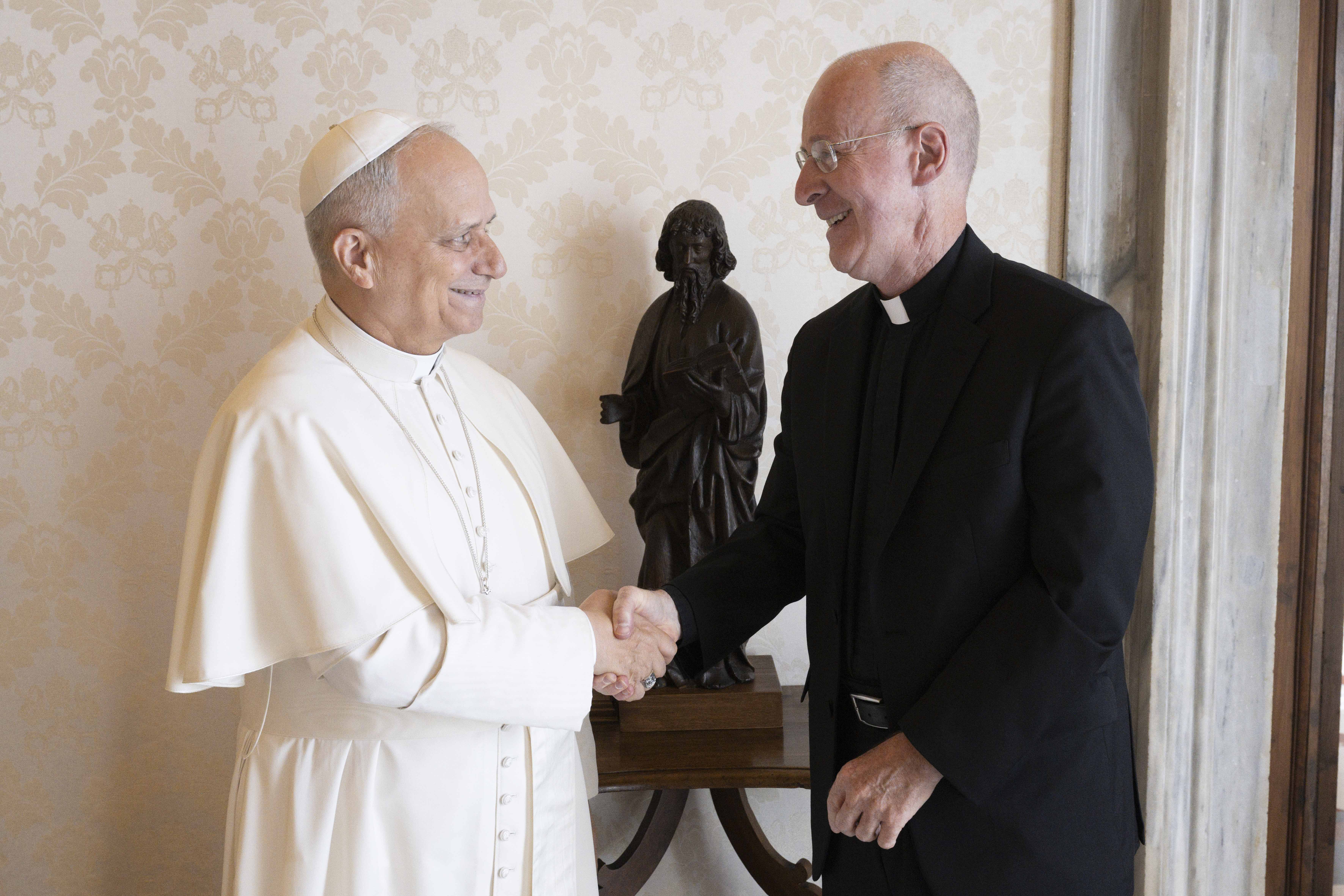 Pope Leo XIV welcomes Jesuit Father James Martin, an author and editor at large at America magazine, to the library of the Apostolic Palace at the Vatican Sept. 1, 2025. (CNS photo/Vatican Media)