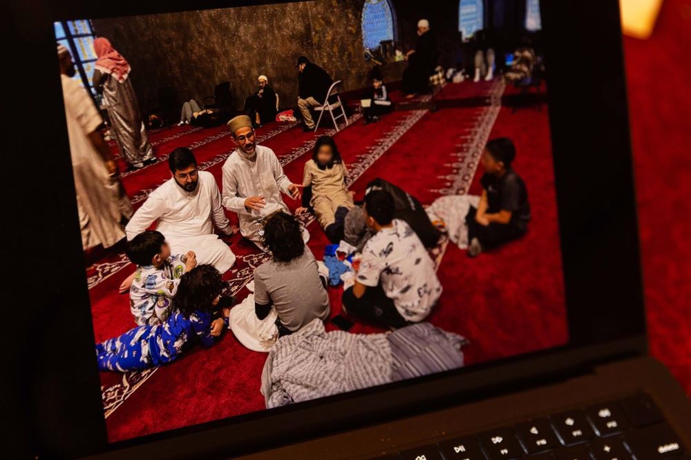 Ayman Soliman, center, talks to children at a Cincinnati mosque. Soliman is in ICE detention and facing deportation to Egypt. (Faces blurred by ProPublica) (ProPublica/Maddie McGarvey) 