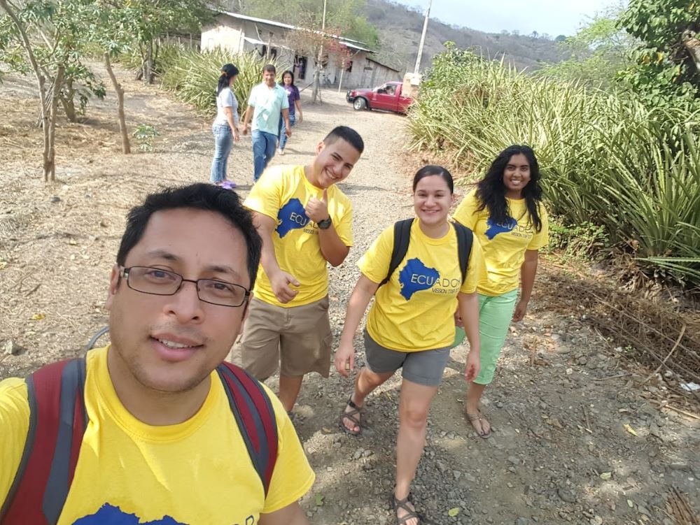 Then Fr. Pedro Bismarck Chau of Newark walks with a group of students, all wearing yellow shirts.  a 2017 mission trip to Ecuador in response to the 2016 earthquake. Chau was then a campus minister for Rutgers University and the New Jersey Institute of Technology. (Courtesy of Pedro Bismarck Chau)