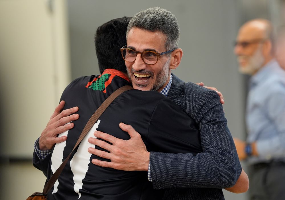 Ayman Soliman is greeted by a supporter as he arrives for a news conference at the Clifton Mosque in Cincinnati Sept. 19 after being released from ICE custody. (AP/Carolyn Kaster)