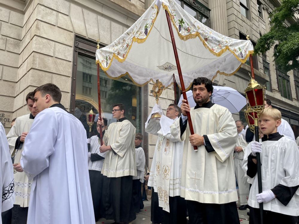 Opus Dei Fr. Charles Trullols carries the monstrance with the Blessed Sacrament at the start of a Eucharistic procession through the streets of Washington May 18, 2024. (OSV News photo/Katie Yoder, Our Sunday Visitor)