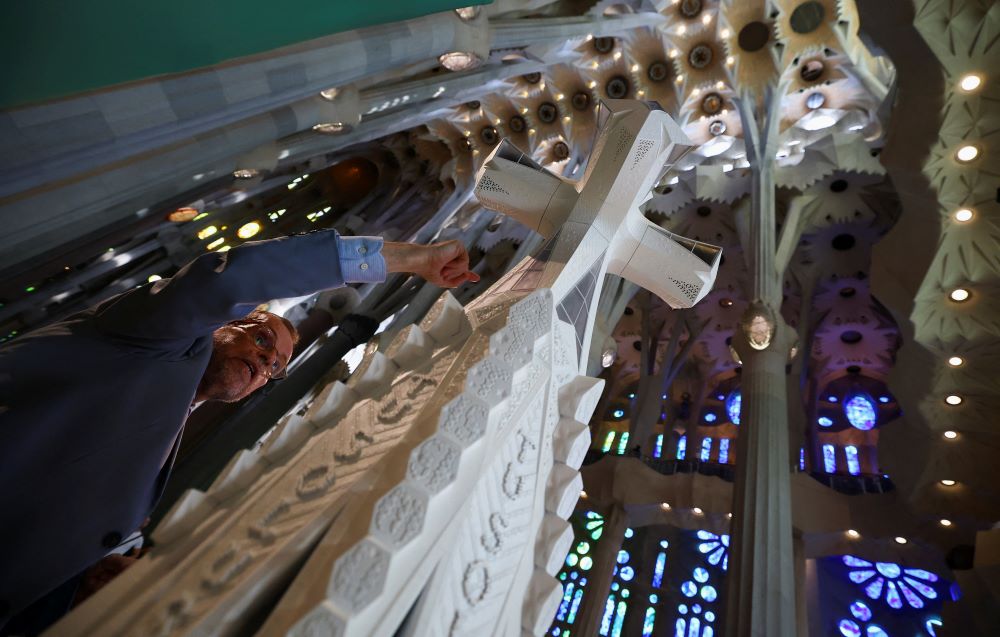 Sagrada Familia head architect Jordi Fauli points at a cross during a news conference to announce an update on the works of the basilica in Barcelona, Spain, Sept. 18. (OSV News/Reuters/Albert Gea)