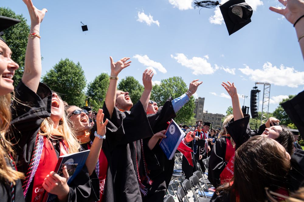 Graduates toss their caps in celebration at the Catholic University of America commencement ceremony May 17 in Washington.