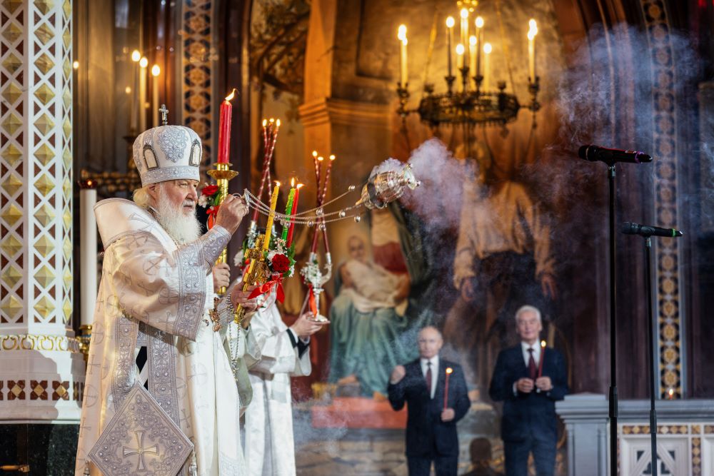 Russian Orthodox Church Patriarch Kirill, left, leads the Orthodox Easter service as Russian President Vladimir Putin, left, and Moscow Mayor Sergei Sobyanin stand nearby.