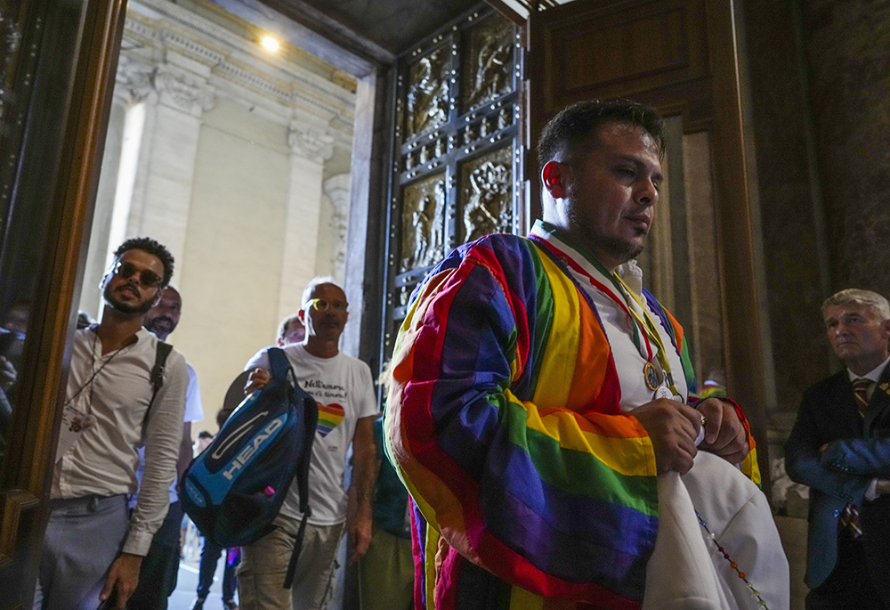Some of the hundreds of LGBTQ+ Catholics and their families who joined a Holy Year pilgrimage to Rome, celebrating a new level of acceptance in the Catholic Church and crediting Pope Francis for the change, walk through the Holy Door of St. Peter's Basilica at the Vatican, Saturday, Sept. 6, 2025. (AP photo/Andrew Medichini)