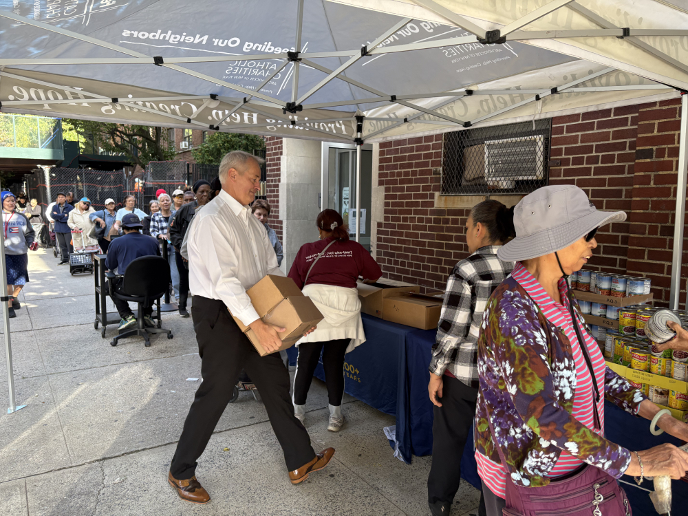 Catholic Charities New York CEO J. Antonio Fernández helps carry and open food boxes at a food pantry at St. Cecilia’s Church in East Harlem, New York, Sept. 2025. (NCR photo/Camillo Barone)