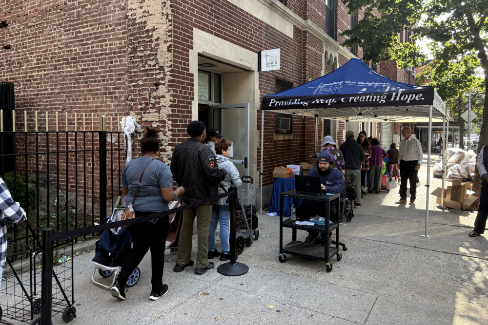 Catholic Charities New York CEO J. Antonio Fernández dressed in a white shirt, supervises a food pantry at St. Cecilia’s Church in East Harlem, New York, Sept. 2025. (NCR photo/Camillo Barone)