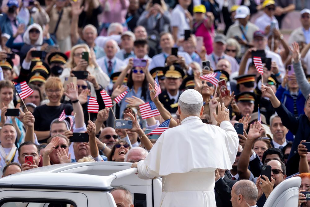Pope Leo XIV greets visitors and pilgrims from the popemobile before his weekly general audience, with people waving US flags,in St. Peter's Square at the Vatican Oct. 1. (CNS/Pablo Esparza)
