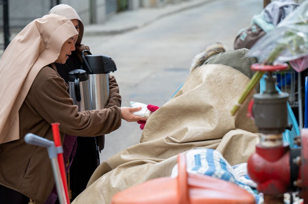 Sisters Poor of Jesus Christ distribute food and talk with people experiencing homelessness on the streets of downtown Baltimore May 3, 2023. (OSV News/Kevin J. Parks, Catholic Review)