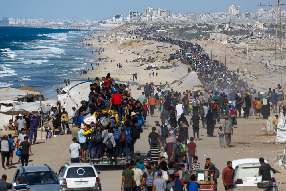 Palestinians make their way along a road in the central Gaza Strip as they return to the north Oct. 10 after a ceasefire between Israel and Hamas in Gaza went into effect. 