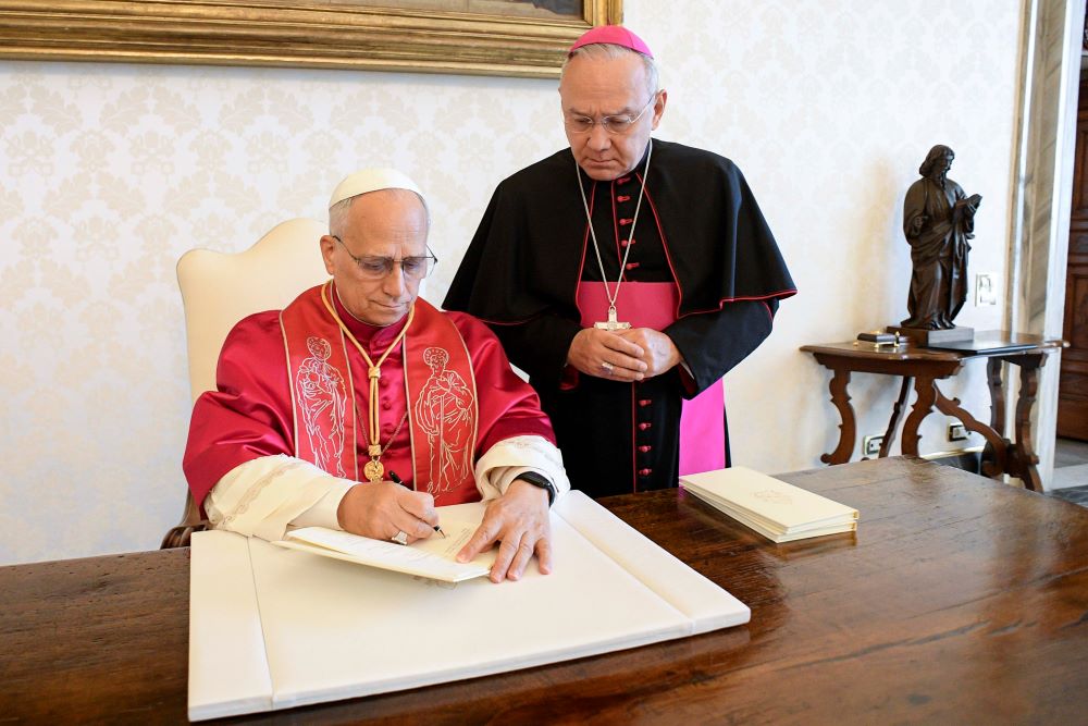 Pope Leo XIV signs his first apostolic exhortation, "Dilexi Te" ("I Have Loved You"), in the library of the Apostolic Palace