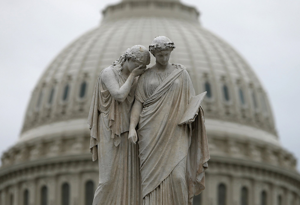 The statue of Grief and History stands near the U.S. Capitol dome in Washington, in this 2013 file photo. (CNS photo/Reuters/Kevin Lamarque)