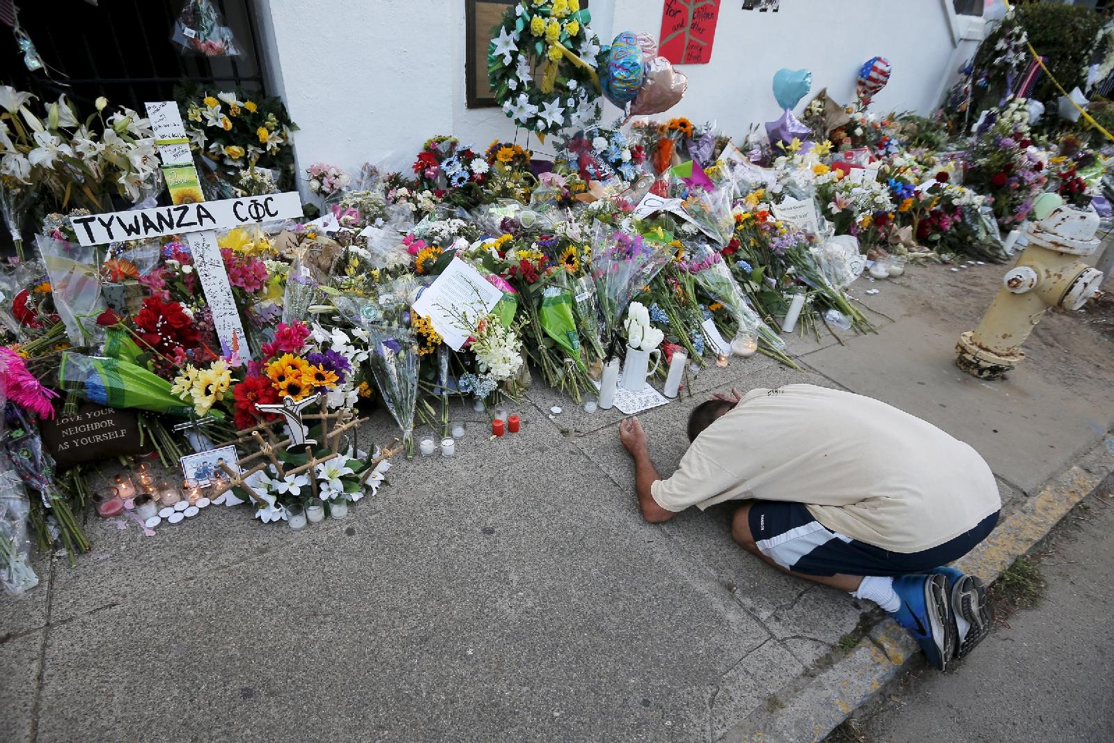 A man pays his respects outside the Emanuel African Methodist Episcopal Church in Charleston, S.C., June 21. Nine African Americans were shot to death by a young white man at an evening Bible study inside the church June 17. (CNS/Brian Snyder)