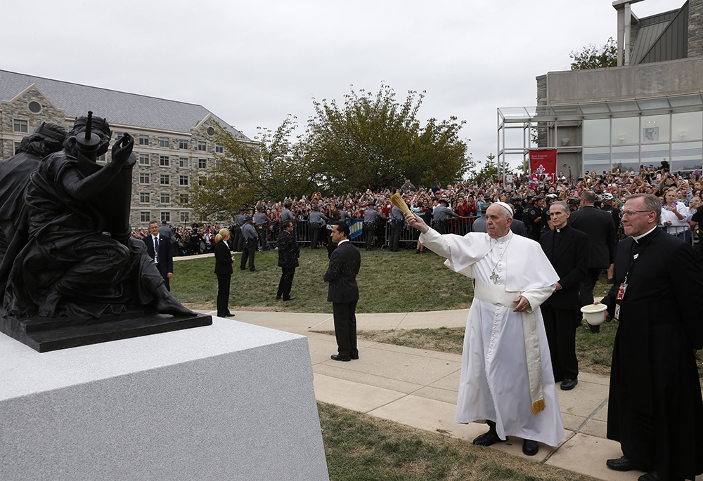 Pope Francis blesses a sculpture during a brief stop at St. Joseph's University in Philadelphia Sept. 27, 2015. The sculpture commemorates the 50th anniversary of "Nostra Aetate," the Second Vatican Council Declaration on the Relationship of the Church to Non-Christian Religions. (CNS photo/Paul Haring)