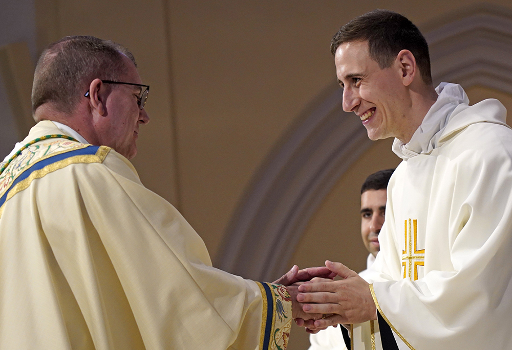 Fr. Stephen Rooney smiles as he exchanges the sign of peace with Bishop John O. Barres of Rockville Centre, New York, during his ordination to the priesthood at St. Agnes Cathedral in Rockville Centre June 18, 2022. (OSV News/Gregory A. Shemitz)
