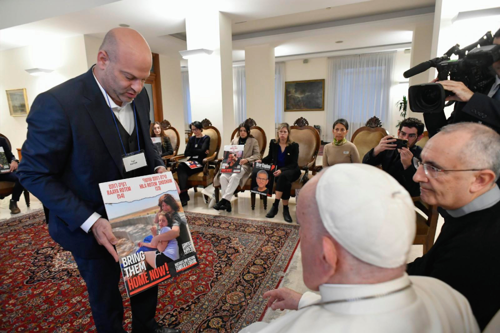 Pope Francis meets relatives of hostages taken by Hamas militants from Israel Oct. 7 in his residence, the Domus Sanctae Marthae, at the Vatican Nov. 22, 2023. Members of the delegation carried posters of their loved ones. (CNS/Vatican Media)