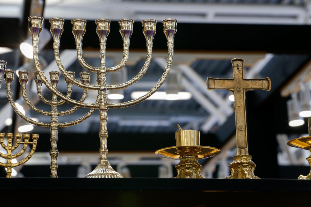 A menorah and crucifix are seen side by side at the International Religious Products and Services Exhibition in Bologna, Italy, Feb. 13, 2024. (CNS/Justin McLellan)