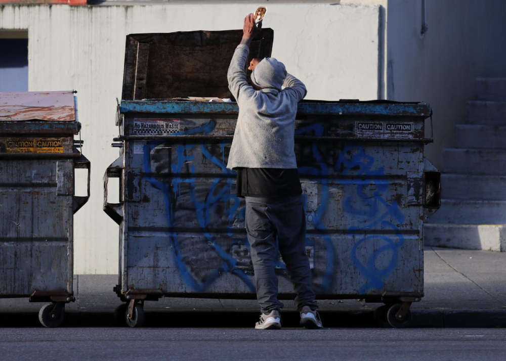 A man pulls food out of a dumpster in San Francisco May 19, 2024. The needs of the homeless and other vulnerable groups in the U.S. have been among the concerns of the U.S. bishops' Catholic Campaign for Human Development as it has provided grants, through an application process, to groups that address societal issues. Other target projects of CCHD, founded in 1970, have included voter registration, credit unions, job training programs, cooperatives and nonprofit housing corporations.