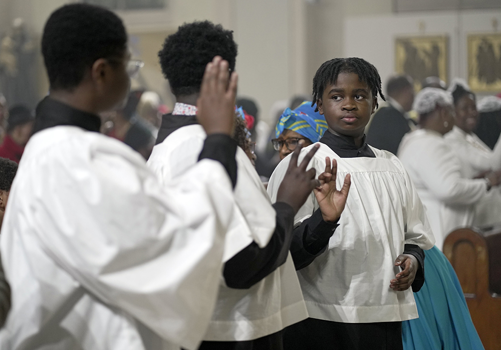 Altar servers exchange the sign of peace during the Diocese of Brooklyn's annual Black History Month Mass of thanksgiving at St. Therese of Lisieux Church in the East Flatbush section of Brooklyn, New York, Feb. 16, 2025. (OSV News photo/Gregory A. Shemitz)