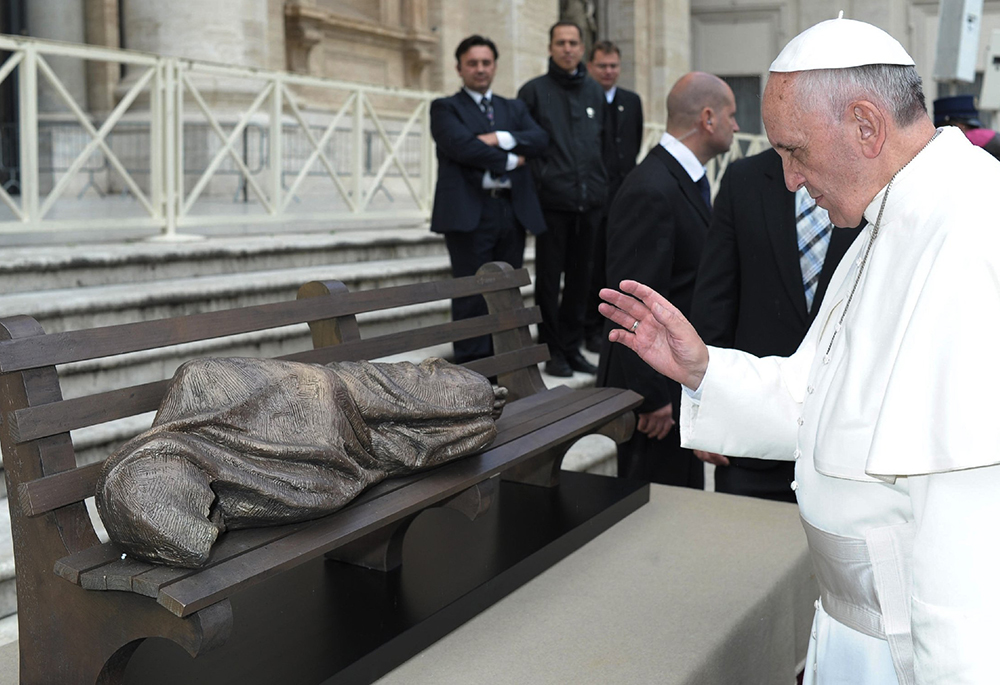 Pope Francis blesses the sculpture "Jesus the Homeless" during his general audience in St. Peter's Square at the Vatican Nov. 20, 2013. When Pope Leo XIV's first apostolic exhortation, Dilexi Te, is read alongside Pope Francis' final encyclical, Dilexit Nos, the two titles become a single theological diptych, writes Stan Chu Ilo. (CNS/L'Osservatore Romano)