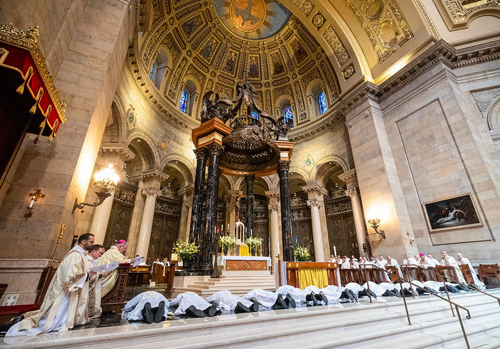 Thirteen men being ordained to the priesthood during a May 25, 2024, Mass at the Cathedral of St. Paul in St. Paul, Minn., lie prostrate during the litany of saints. (OSV News file/The Catholic Spirit/Dave Hrbacek)